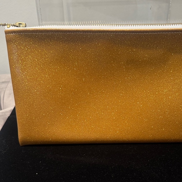 Julie Mollo, NYC, gold sparkle clutch. Sweet XOXO zipper....